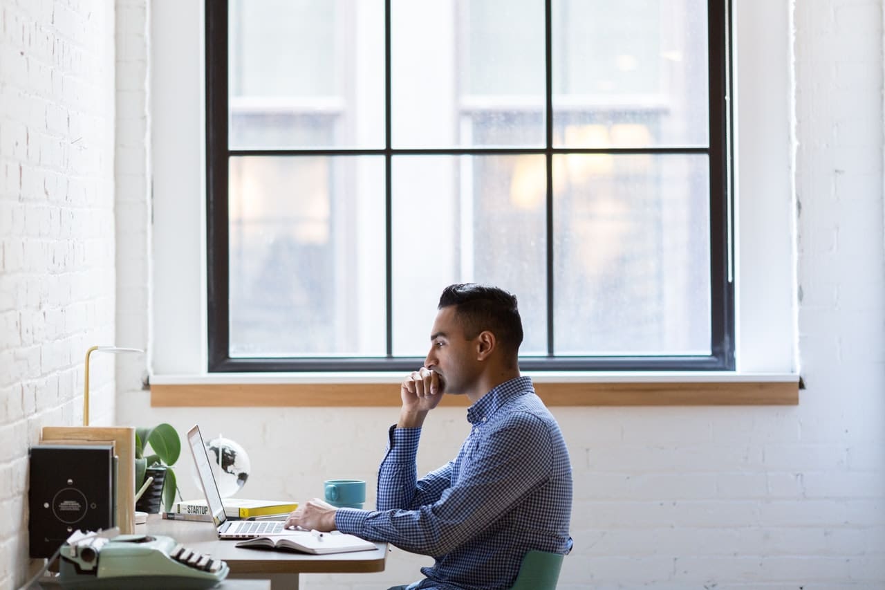 Man works on WordPress website in web design office