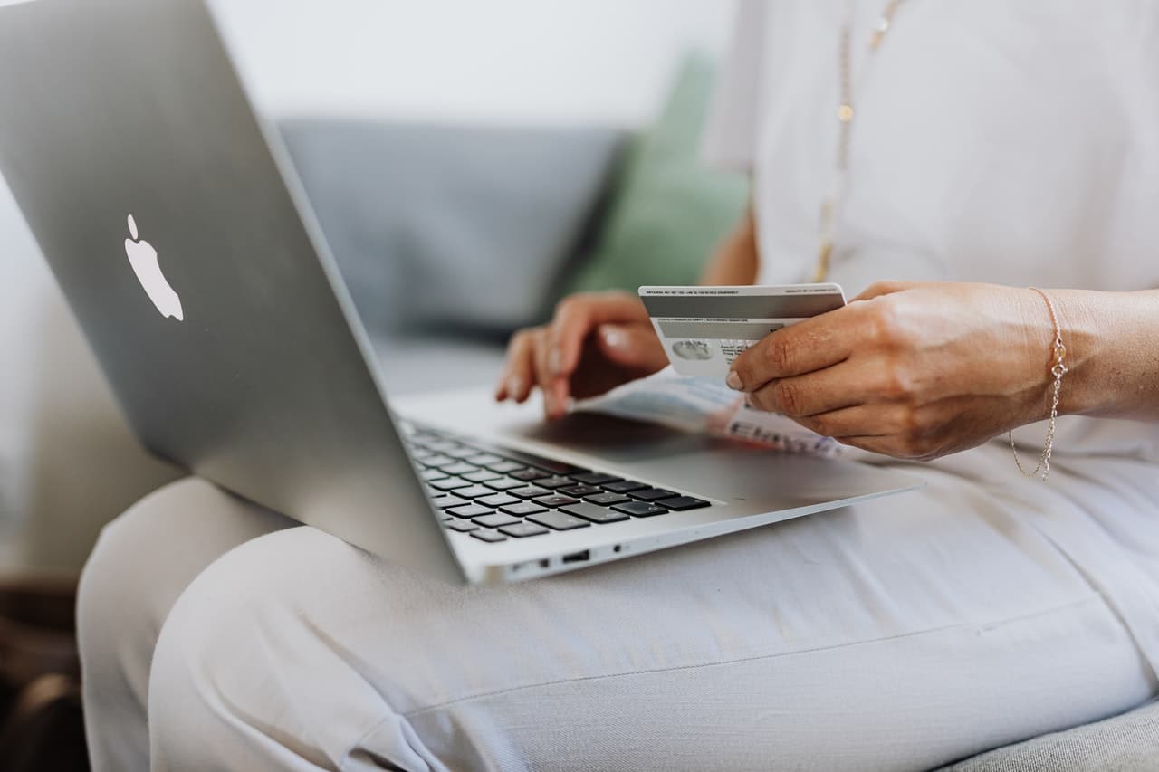 Woman making purchase on e-commerce website on laptop