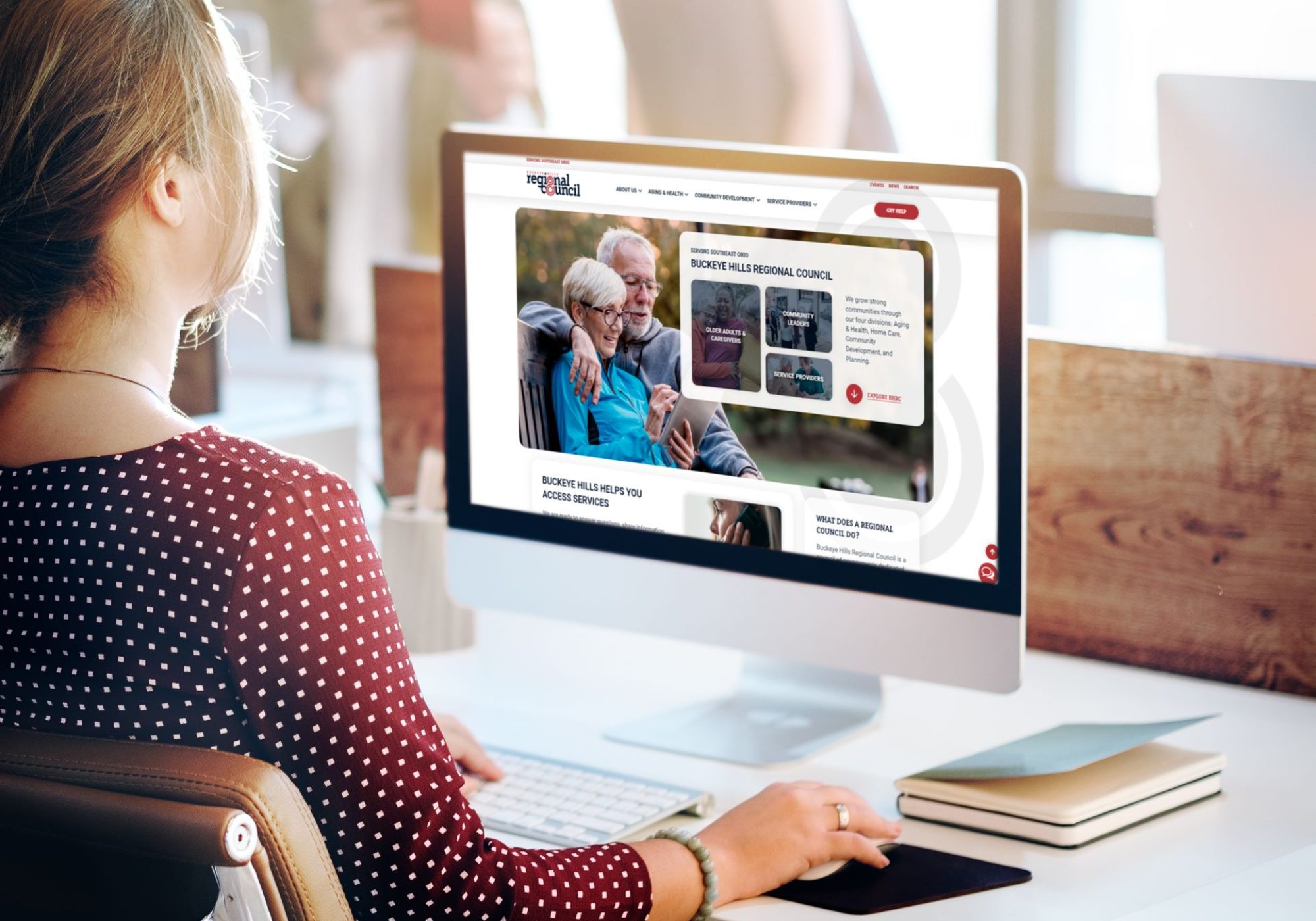 Woman at desk looking at Buckeye Hills Regional Council Desktop Mockup