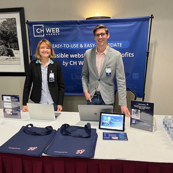 CHWeb Agency team in from of their booth